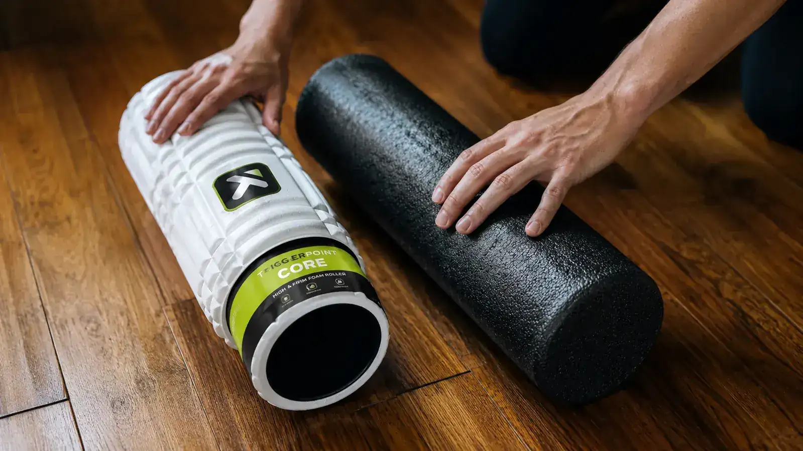 Side-by-side comparison of the TriggerPoint CORE and a plain black budget foam roller showing surface texture difference